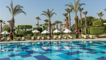 Indoor pool, 7 outdoor pools, open 7:00 AM to 7:00 PM, pool umbrellas