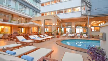 Seasonal outdoor pool, open 8:30 AM to 8:00 PM, pool umbrellas