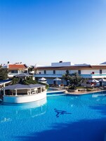 Outdoor pool, an infinity pool, pool umbrellas, sun loungers