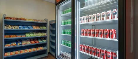 A refrigerated display case with various beverages and snacks.