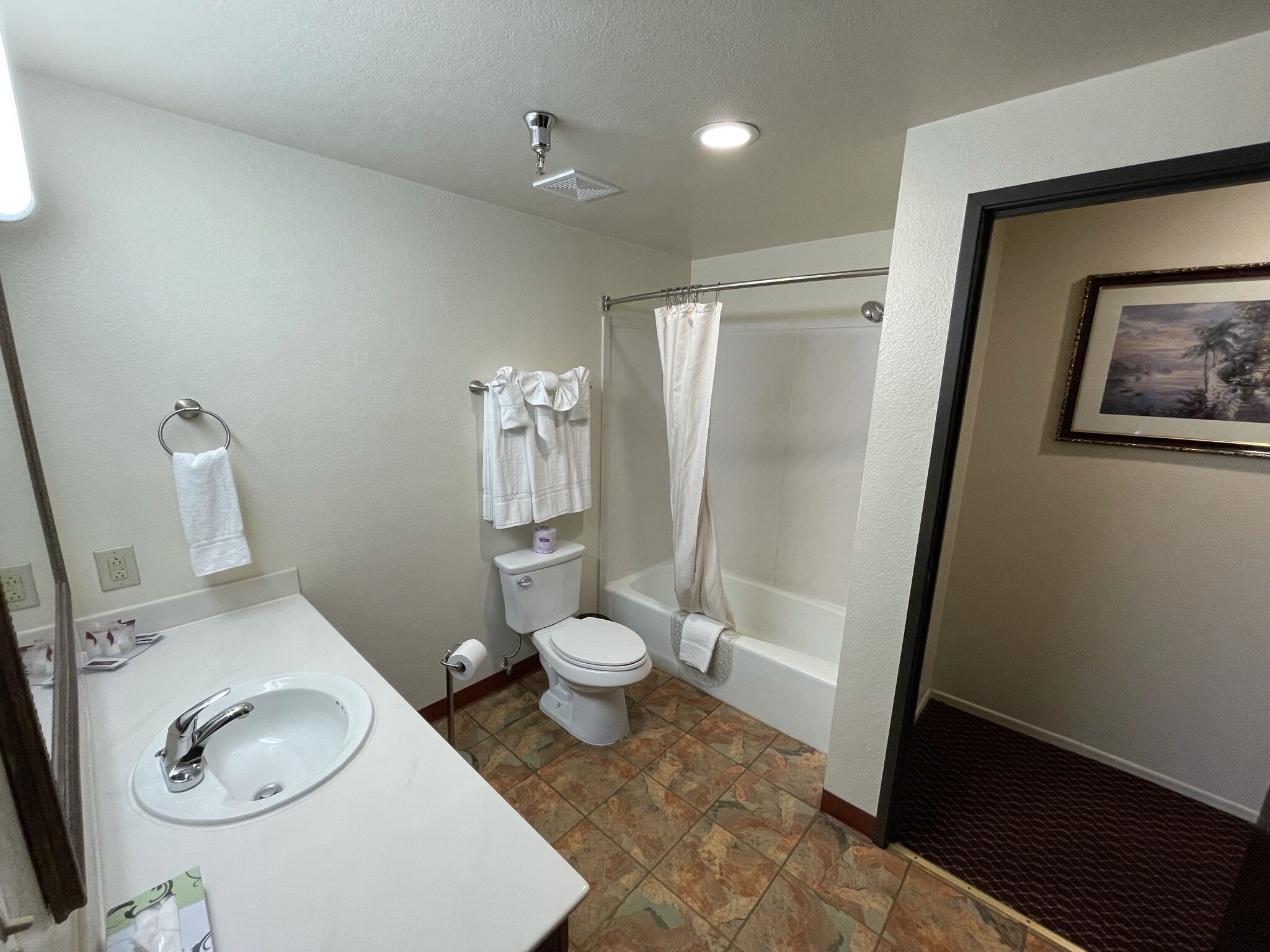 A bathroom with a sink, toilet, and bathtub.