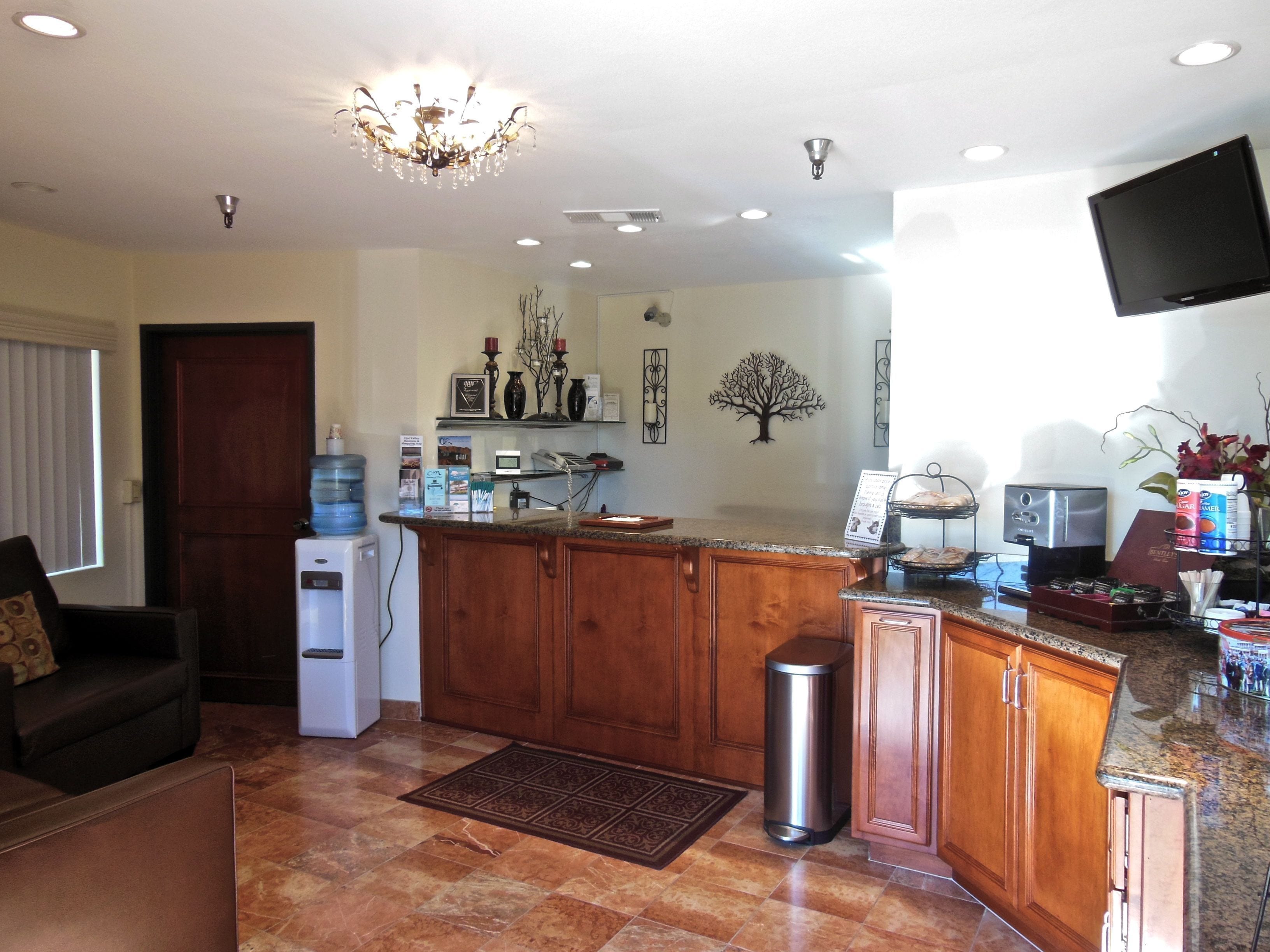Una cocina moderna con encimeras de granito, estufa integrada y cafetera.