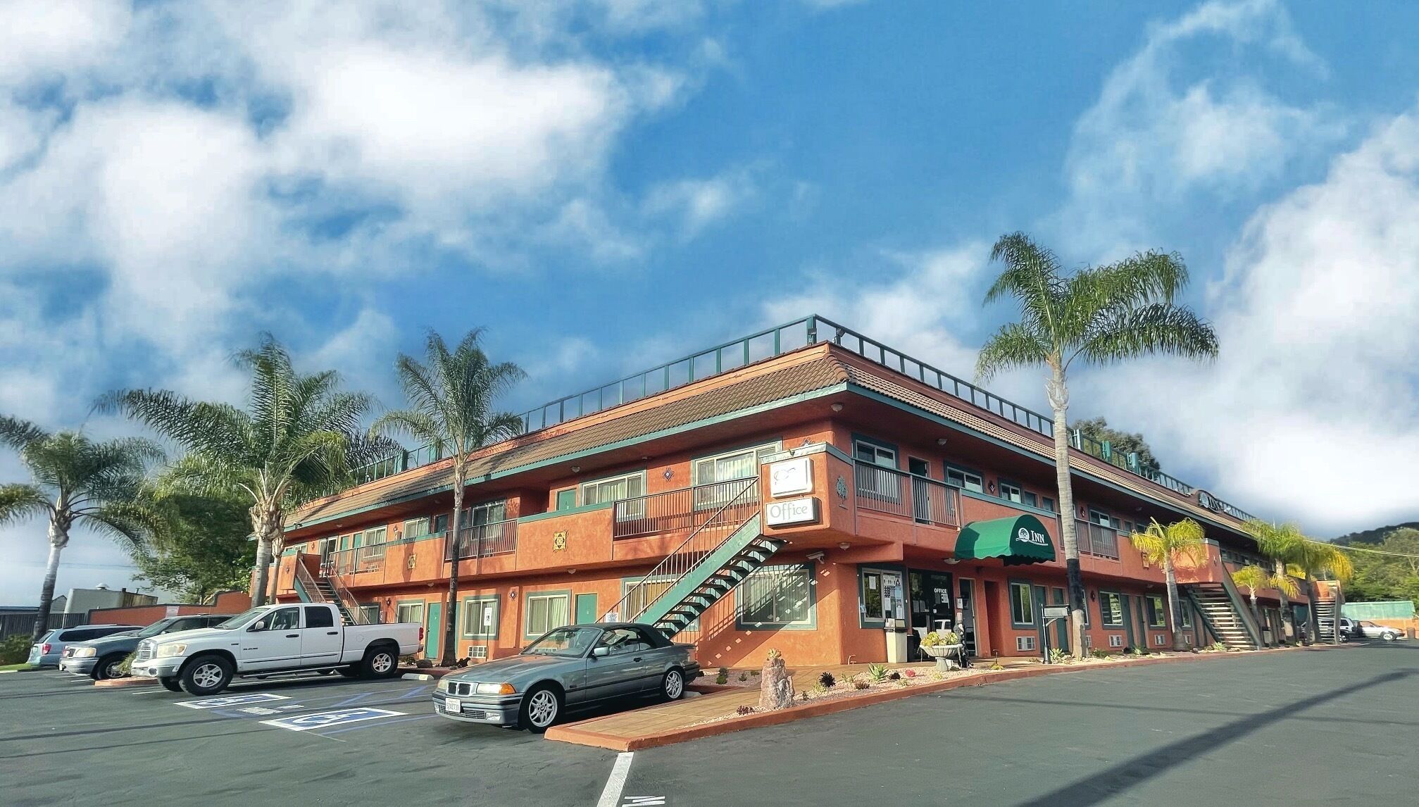 A two-story building with a green awning labeled "Lynn's Office" and a staircase leading to the upper floor.