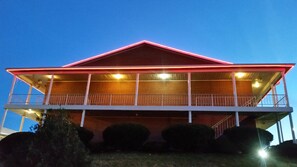 A two-story building with a red roof and white railings.