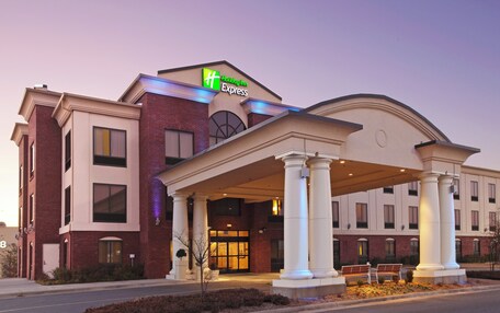 A Holiday Inn Express hotel with a modern facade, large columns, and a welcoming entrance.