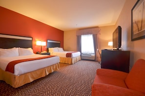 A hotel room with two beds, a TV, a desk, and a couch. - Holiday Inn Express Hotel & Suites Pine Bluff / Pines Mall by IHG (Pine Bluff)