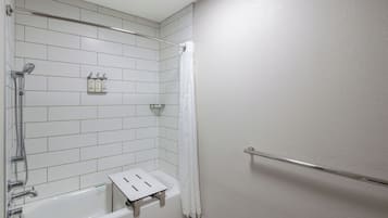 A modern bathroom with a bathtub, shower, and a towel rack.
