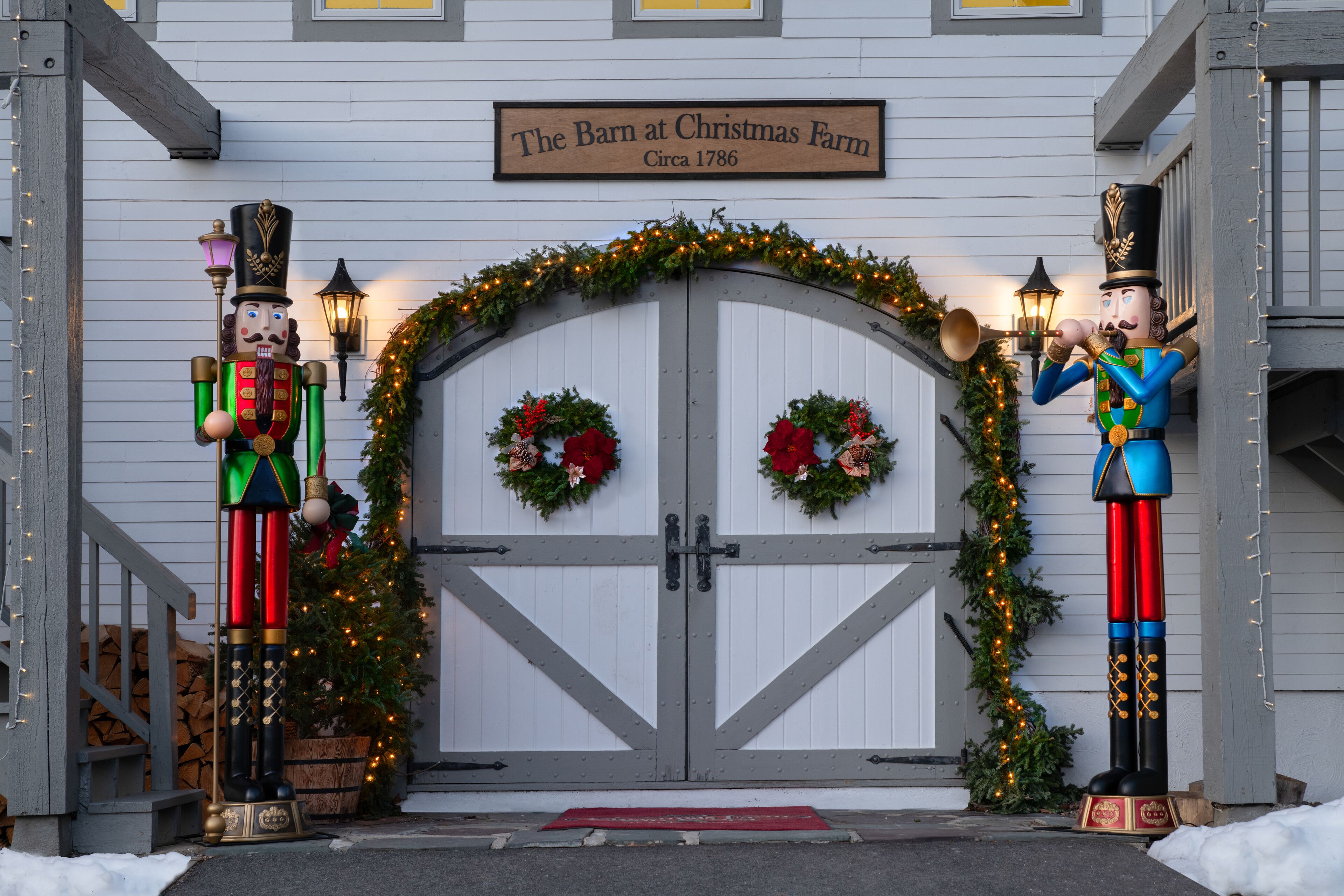 A building with a sign reading "The Barn at Christmas Farm circa 1786."