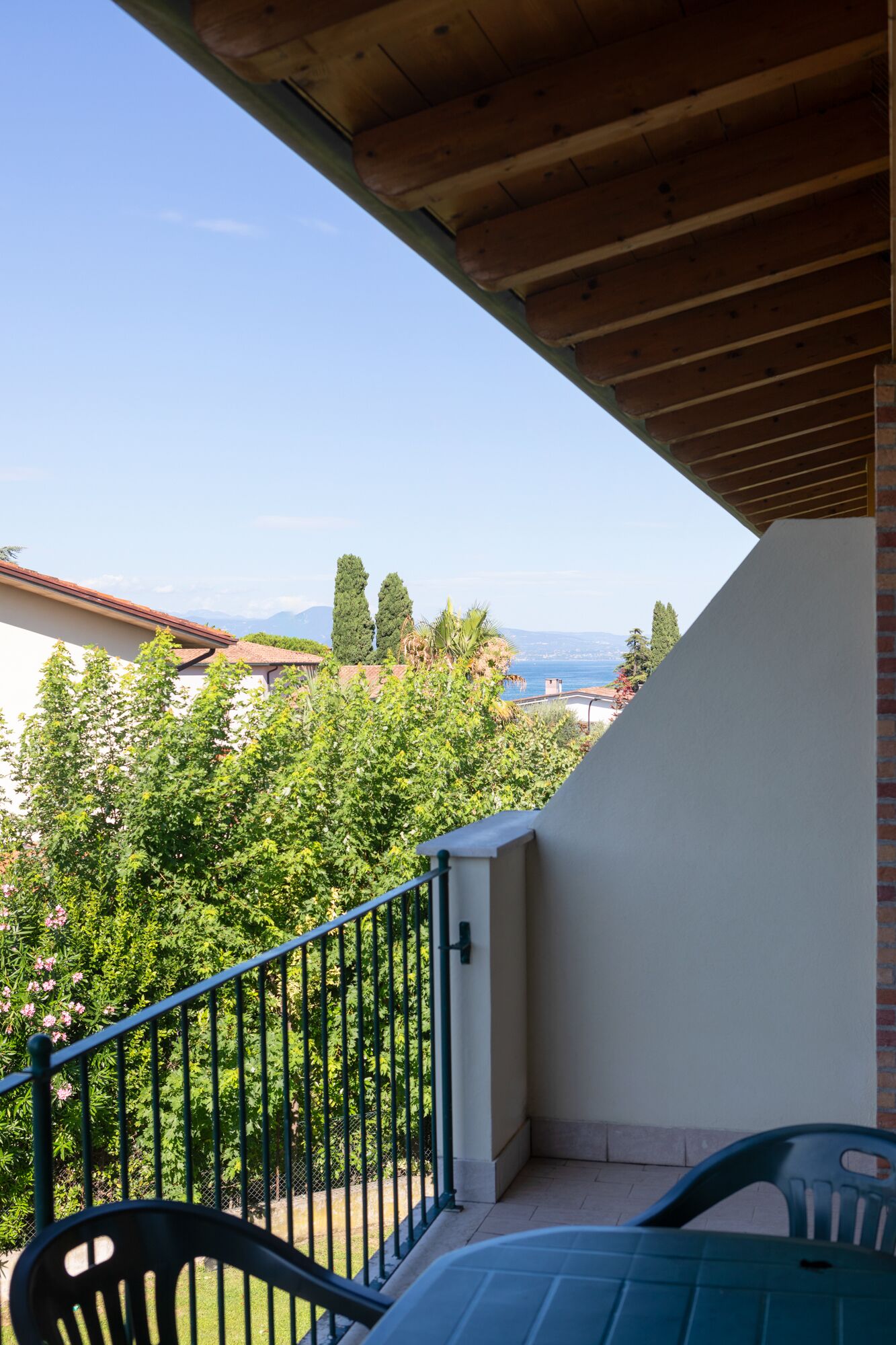 A balcony with a view of the sea and mountains.