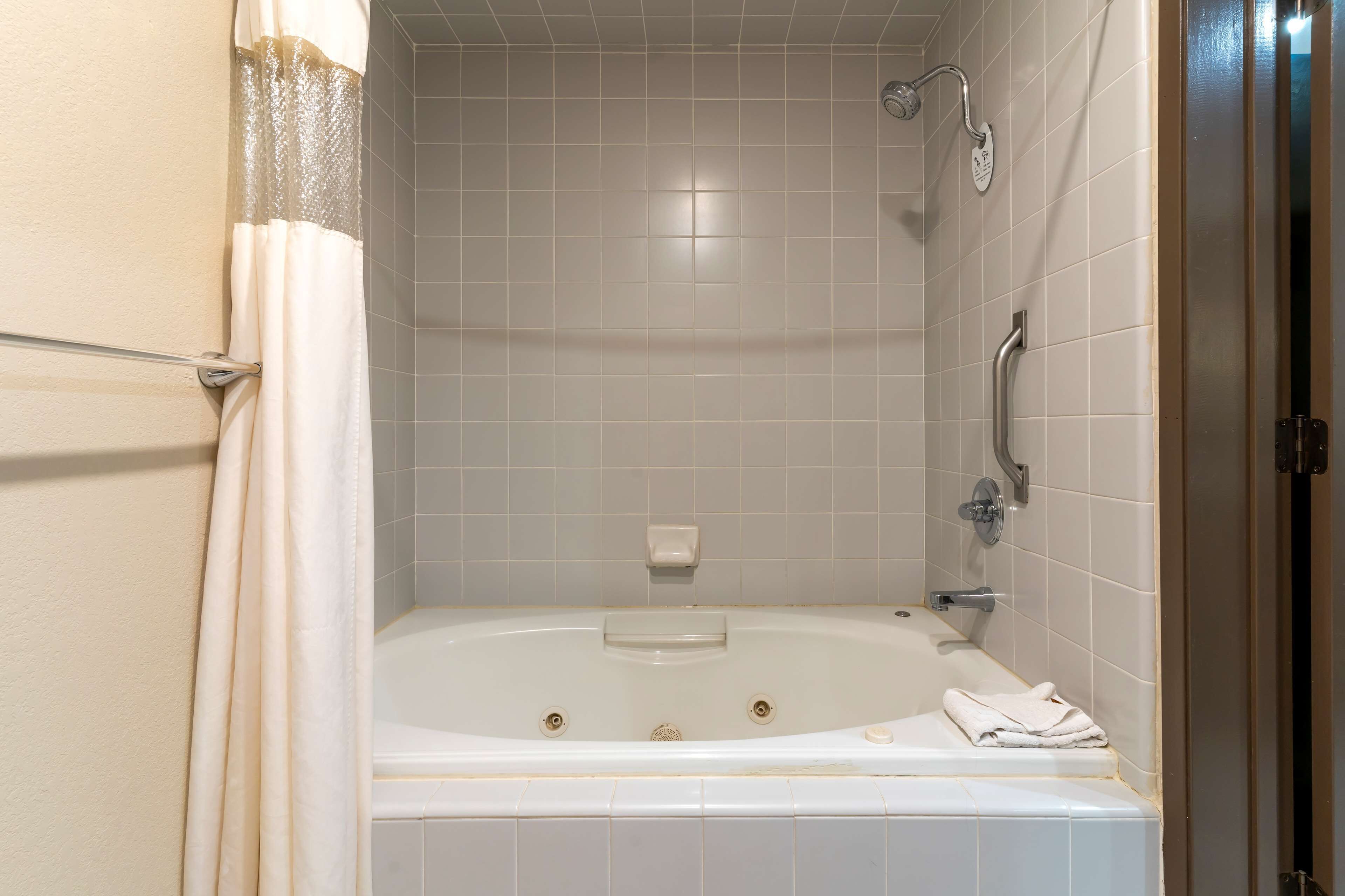 A bathroom with a bathtub, a shower, and a toilet.