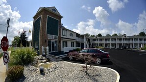 A two-story building with a sign reading "Lodge" and a stop sign nearby.