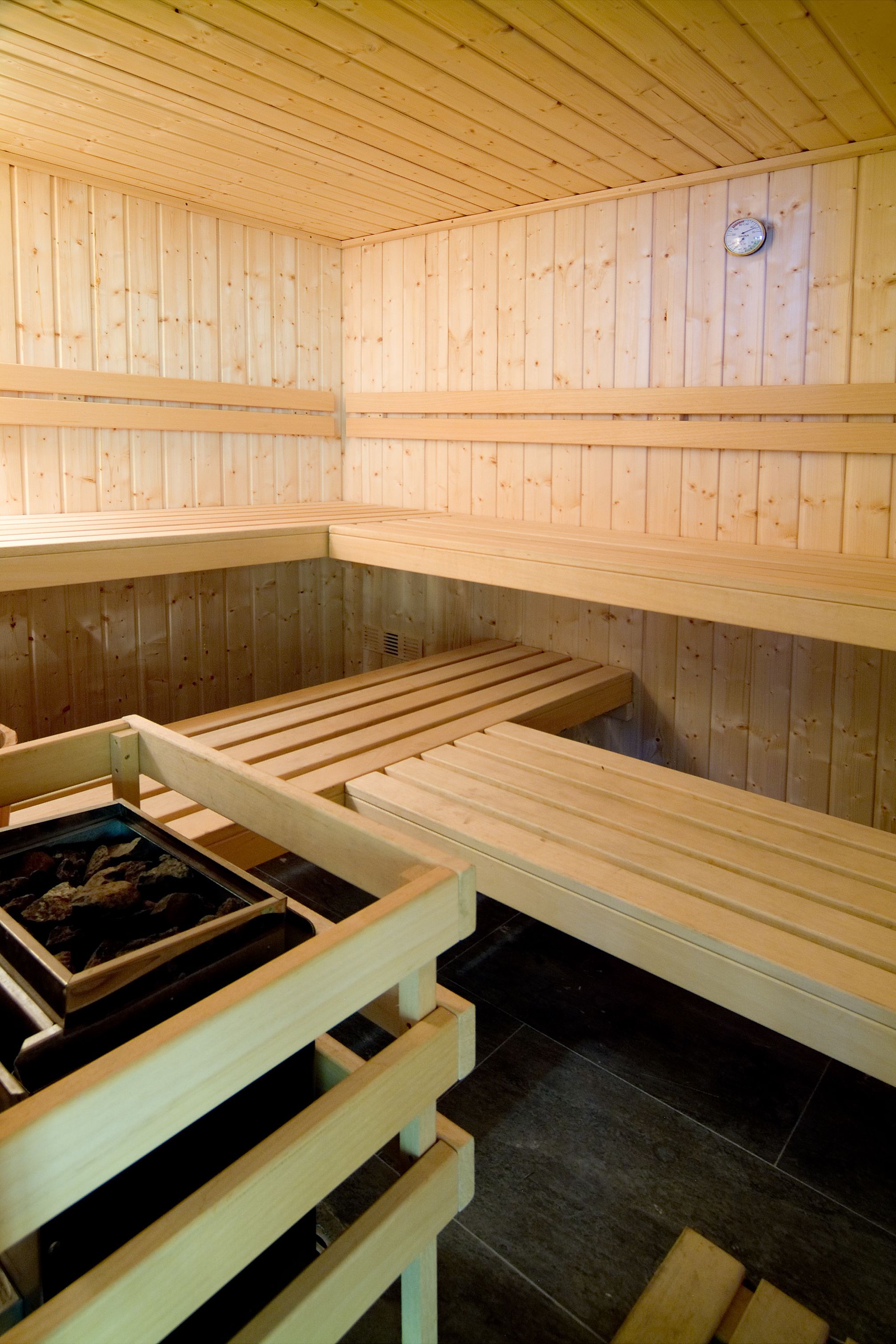 A sauna with wooden benches and a visible heating element.