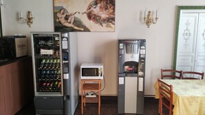 Une chambre équipée d’un distributeur automatique, d’un four à micro-ondes et d’une machine à café.