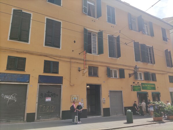 A yellow building with multiple windows and shutters, a sign for 'Hotel Balbi', and a storefront named 'La Focaccia'. - Balbi Hotel (Genoa)