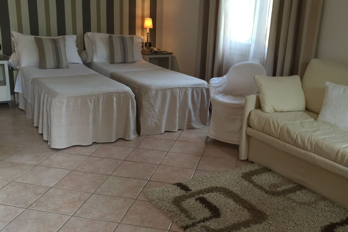 junior suite | minibar, in-room safe, desk, bed sheets