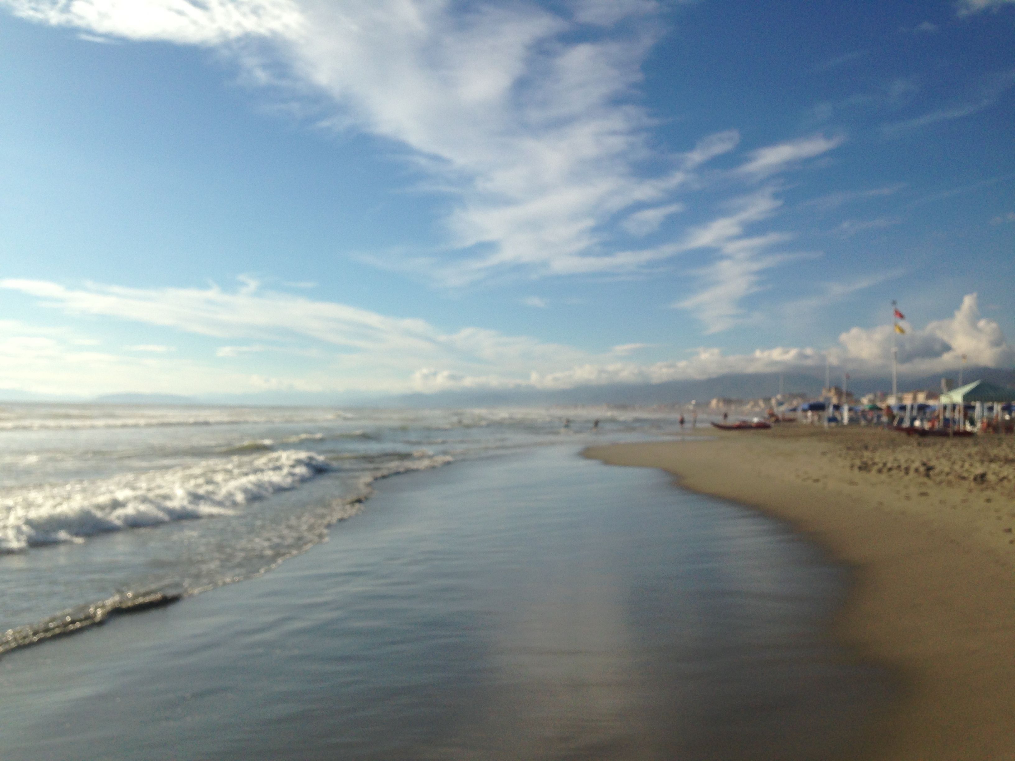 A beach with a sandy shore and a clear sky.