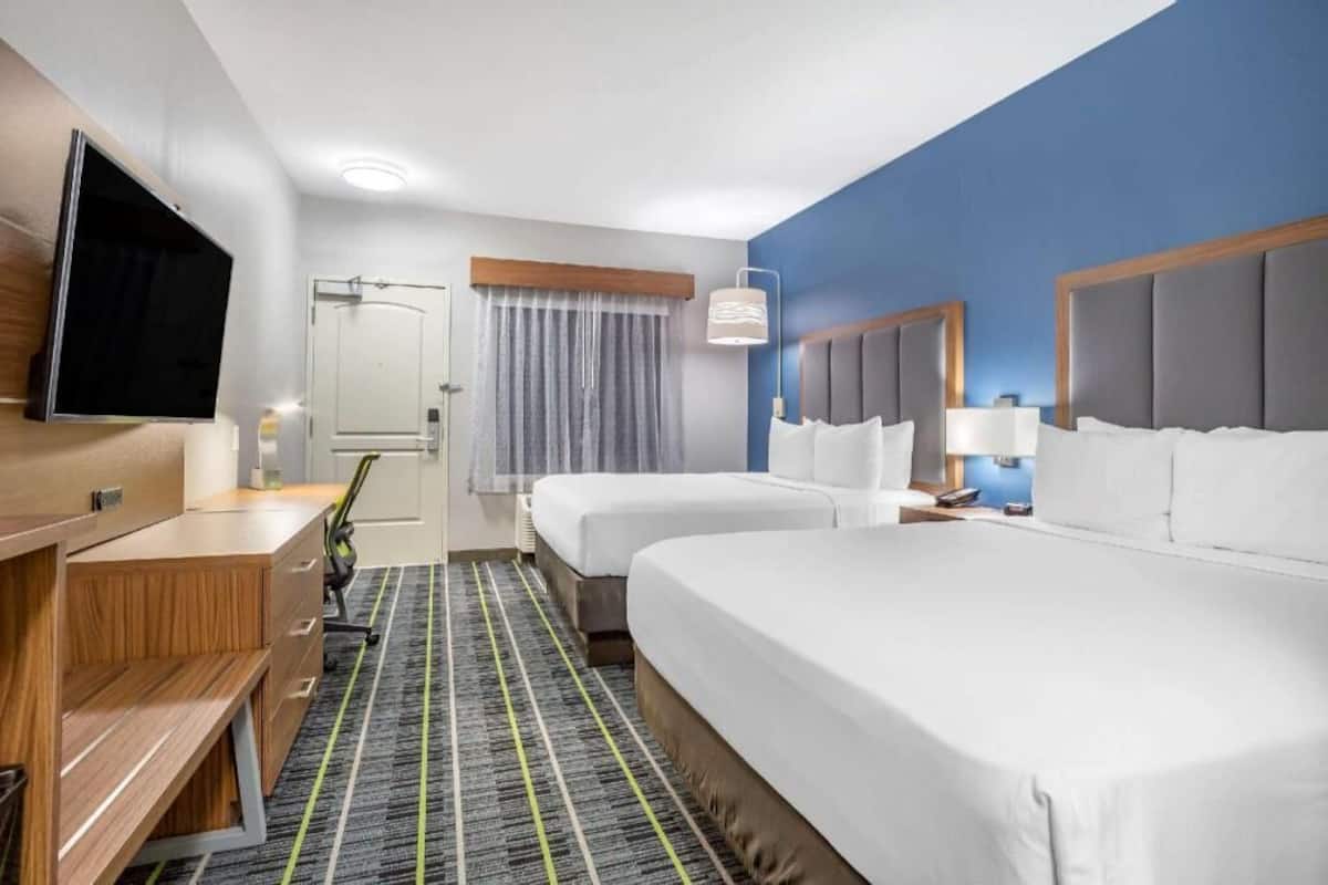 Premium bedding, desk, laptop workspace, blackout curtains