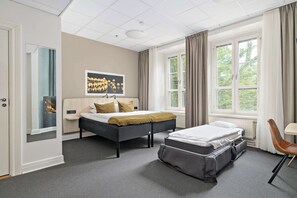 A modern hotel room with a large bed, a smaller bed, a desk, and a chair. - Best Western Hotel Svava (Uppsala)