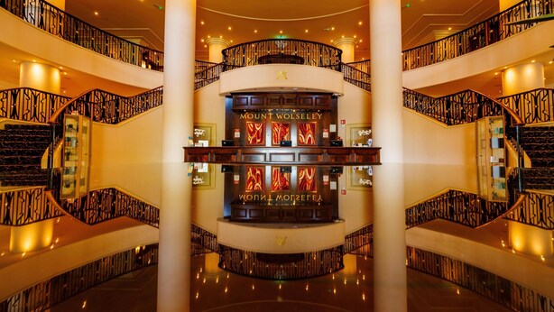 A grand hotel lobby with a central reception desk, multiple floors, and ornate railings. - Mount Wolseley Hotel, Golf and Spa Resort (Tullow)