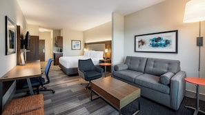 A hotel room with a bed, a sofa, a desk, and a chair. - Holiday Inn Express Hotel & Suites Airdrie-Calgary North by IHG (Airdrie)
