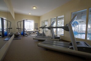 A gym with treadmills, exercise balls, and weight machines.