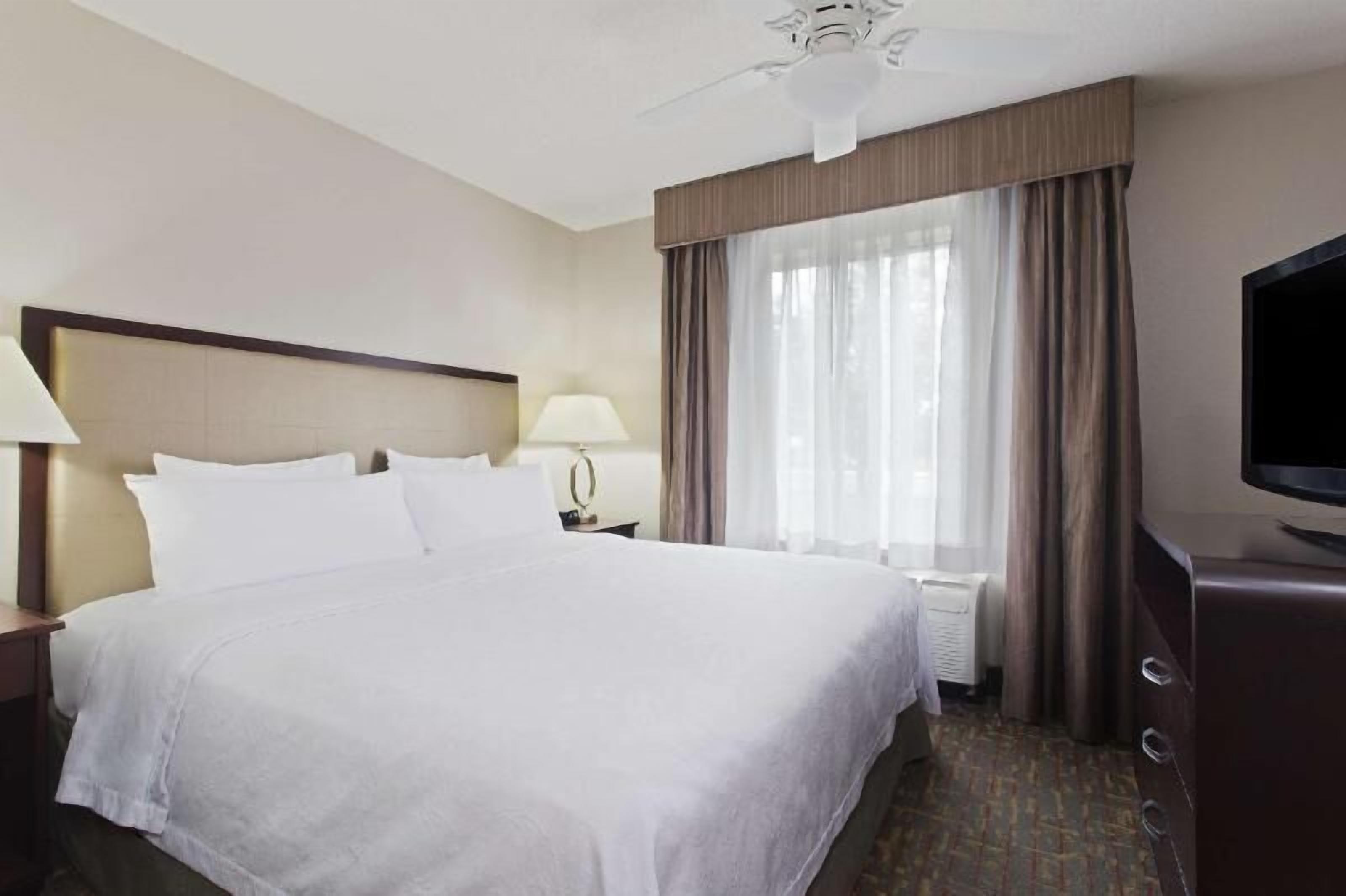 Premium bedding, desk, laptop workspace, iron/ironing board