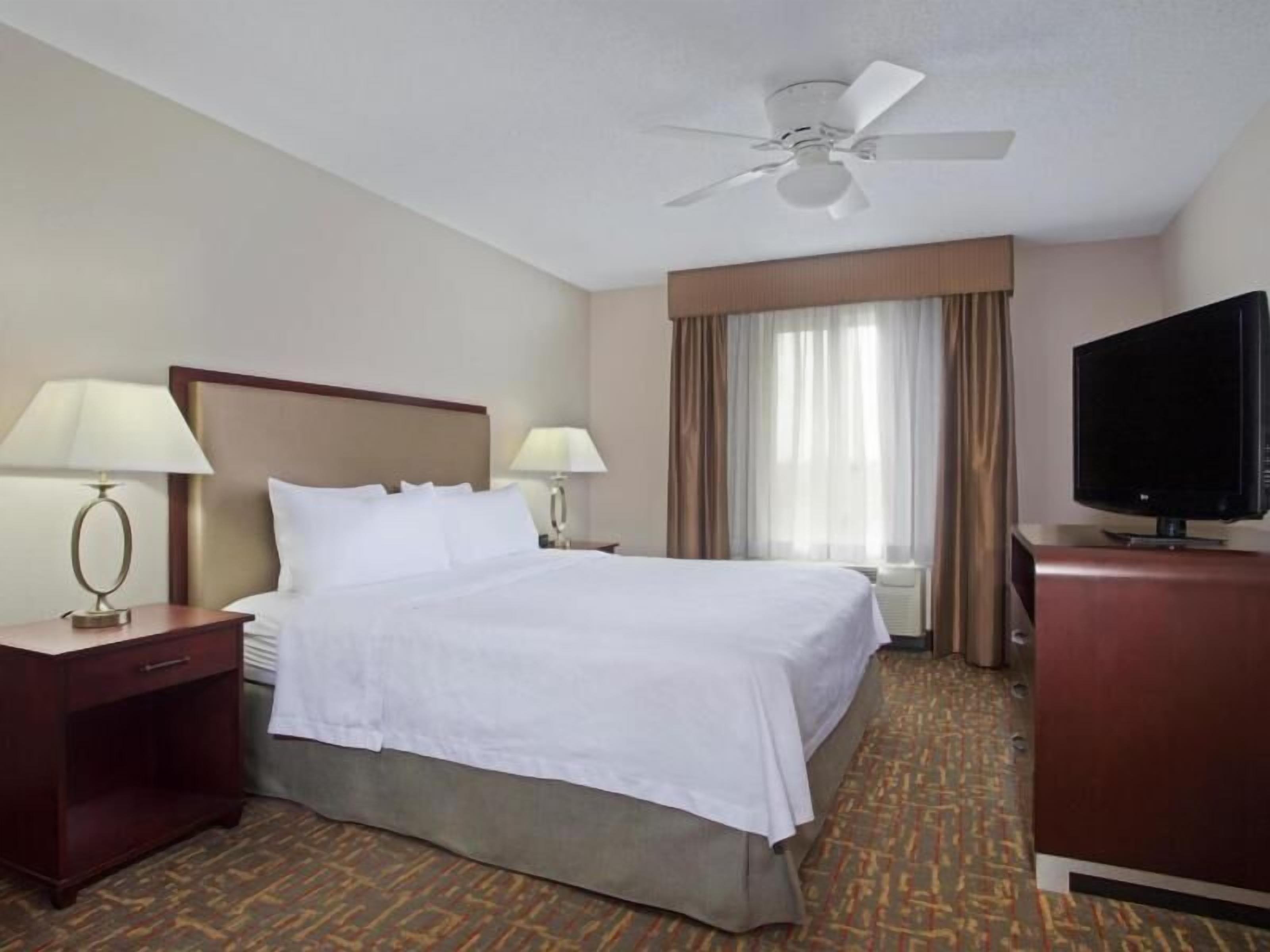 Premium bedding, desk, laptop workspace, iron/ironing board