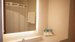 A bathroom with a sink, mirror, and towel rack. - Holiday Inn Express Hotel & Suites by IHG (Logan)