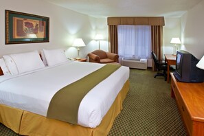 A hotel room with a large bed, a desk with a television, a chair, and two lamps. - Holiday Inn Express Hotel & Suites by IHG (Logan)