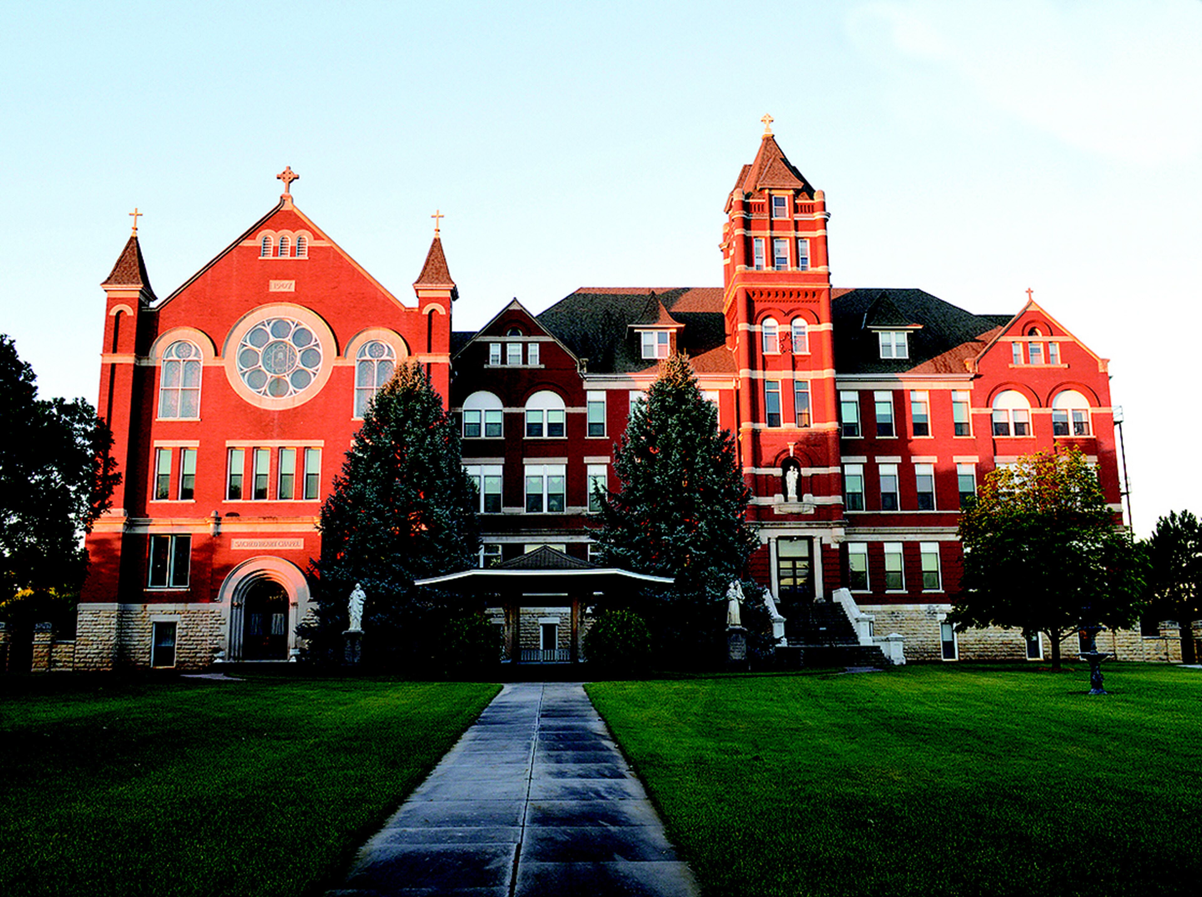 A large red brick building with multiple windows and a central entrance.