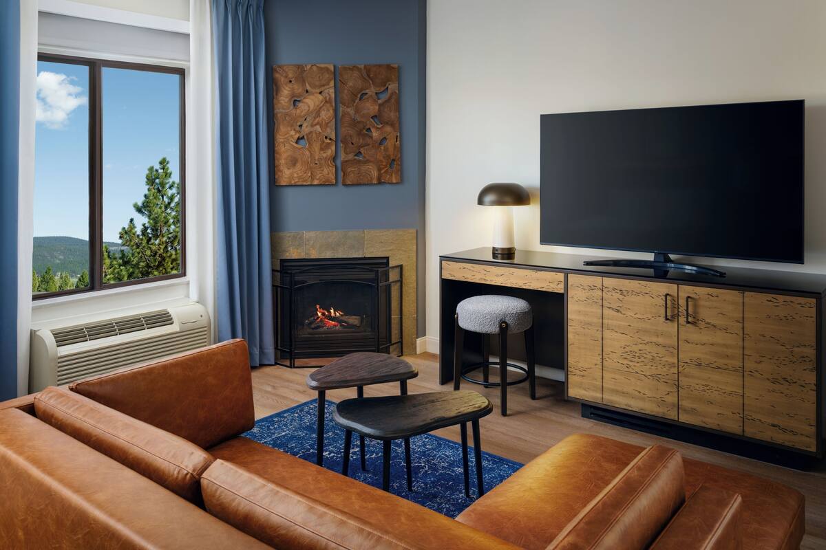 A living room with a fireplace, a TV, and a sofa.