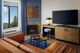 A living room with a fireplace, a TV, and a sofa.