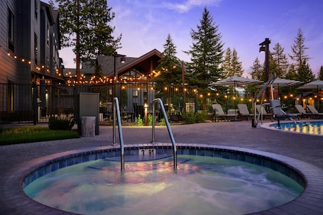 Seasonal outdoor pool, open 8:00 AM to 10:00 PM, pool umbrellas. Martis Valley Lodge, Tapestry Collection by Hilton