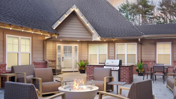 An outdoor patio with a fire pit, seating, and a grill area. - Residence Inn by Marriott Saratoga Springs (Saratoga Springs)