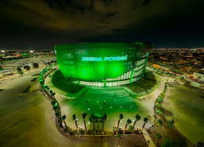 Un estadio con una estructura grande y curvada y una entrada destacada.