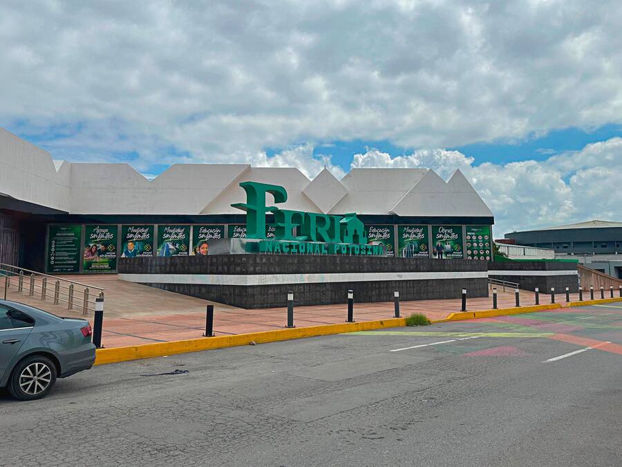 A large building with a prominent green sign reading 'Feria Nacional Potosina.'