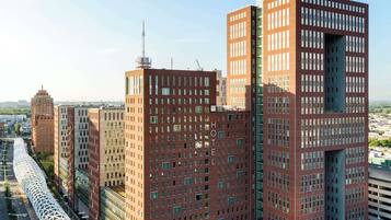 A modern hotel with a distinctive architectural design, featuring a central atrium and multiple floors.