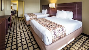 A hotel room with two beds, a desk, and a chair. - Travelers Inn (Phoenix)