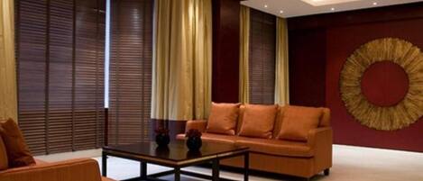 A modern living room with a sofa, coffee table, and decorative vase.