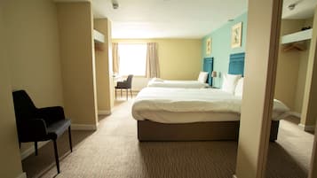 A hotel room with two beds, a desk, and a chair.