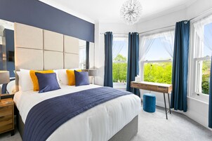 Suite ejecutiva, baño privado (The Torre Suite) | Tabla de planchar con plancha, wifi gratis, ropa de cama