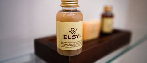 A bottle of ELSYL bath and shower gel on a glass shelf.
