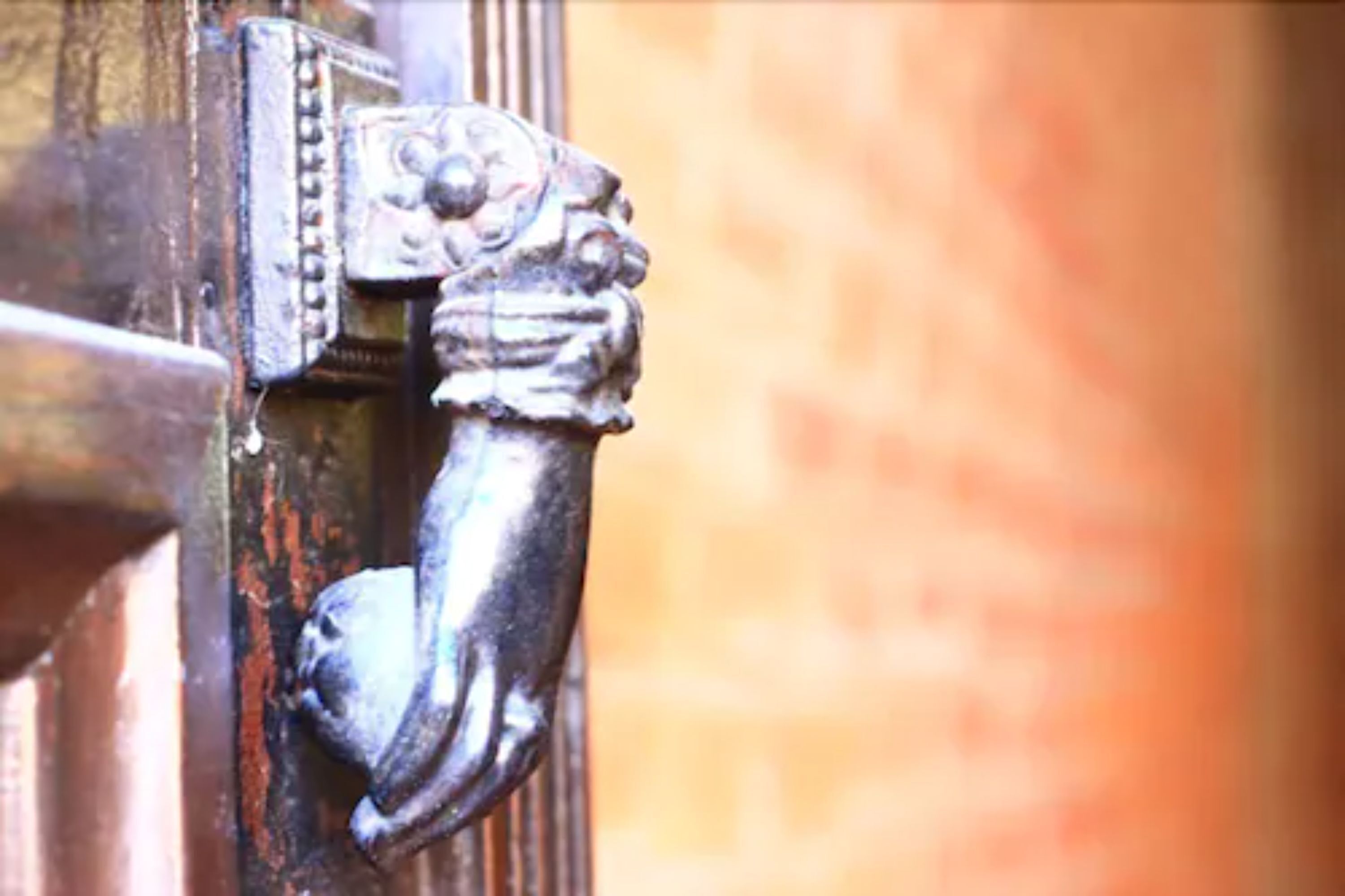 A close-up of a metal door handle with intricate designs.