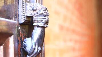 A close-up of a metal door handle with intricate designs.