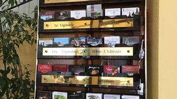 A vertical display board with various categories of local attractions and activities, including Dordogne, tourism, Le Vignoble, wine, château, art, culture, shopping, and leisure.