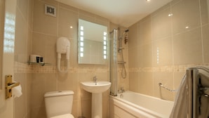 A bathroom with a toilet, sink, and bathtub. - The Minster Hotel York (York)