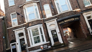 A traditional brick building with a sign for the Hotel Minster Hotel. - The Minster Hotel York (York)
