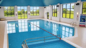 An indoor swimming pool with clear windows, a lifeguard chair, and a pool ladder. - The Wiltshire Hotel, Golf and Leisure Resort (Swindon)