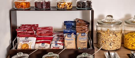 A self-serve breakfast station with various food items and condiments.