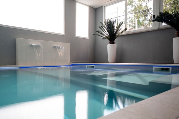 Indoor pool, a waterfall pool, pool loungers